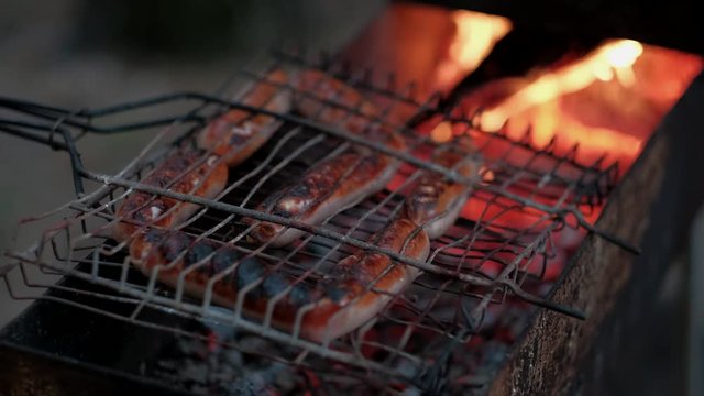 close up fried sausages on the grill