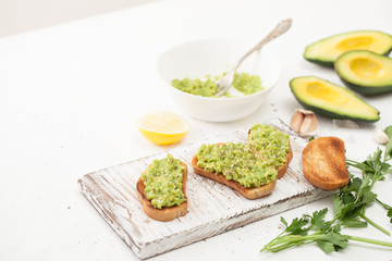 Cooking guacamole avocado on a white table