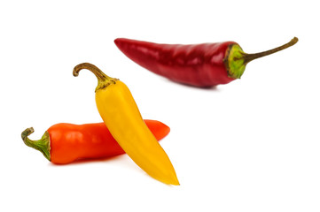 three chili peppers on white