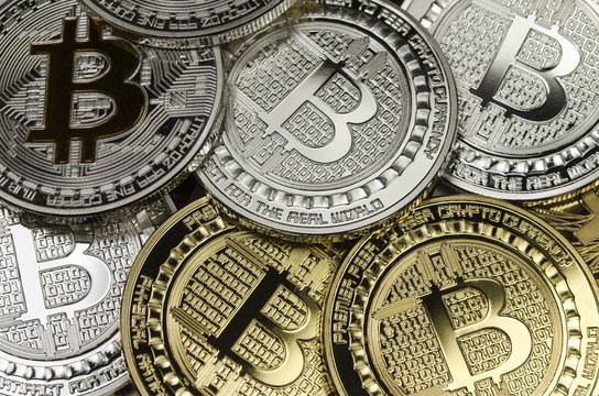 Many Bitcoin coins with currency symbol laying
