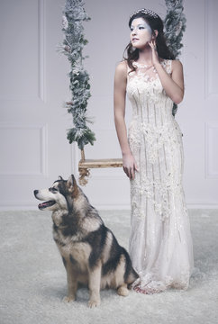 Full length portrait of ice queen with dog