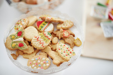 Dish of decorated easter biscuits on kitchen counter