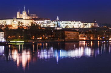 Fototapeta na wymiar Classic evening view of the Vltava River and the historic center of Prague with a majestic castle