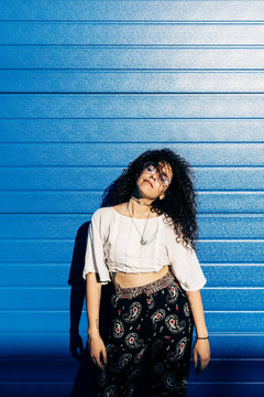 Woman posing against roller shutters
