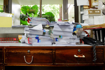 Busy, messy and cluttered workplace, full of documents