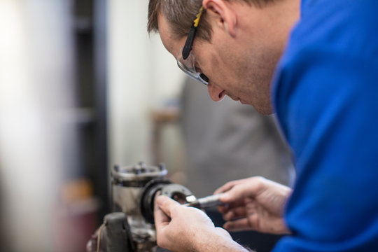 Male car mechanic working in repair garage