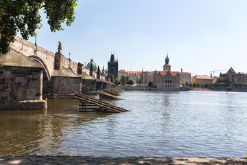 Fototapeta na wymiar The Vltava River and the Charles Bridge are a summer sunny day. Prague, Czech Republic.