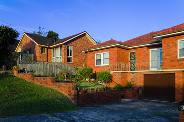 Suburban red brick house exteriors at sunset in Sydney Australia