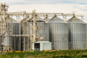 Agricultural grain dryer complex close-up. Modern granary with weighing station.