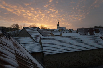 sunrise over romantic winter village