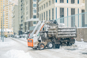 Machine remove snow from a city street