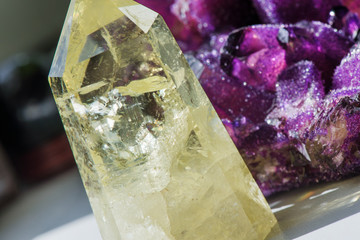 Citrine stone and amethyst. Yellow, clear crystal with dark, smokey color, smoky quartz with ornaments and rainbows in it. Amethyst is a violet variety of quartz used in jewelry. Meditative, powerful 