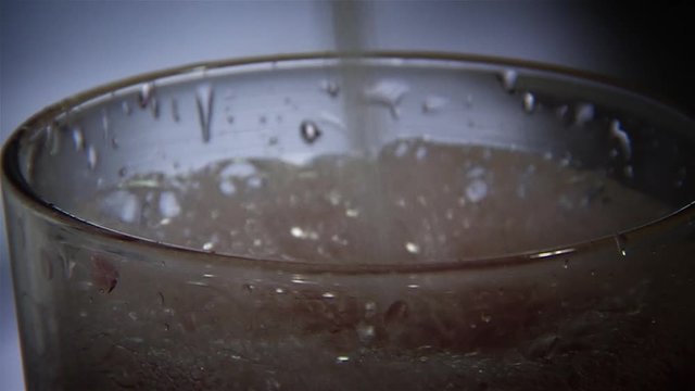 Filling a glass with siphon soda. Close-up.