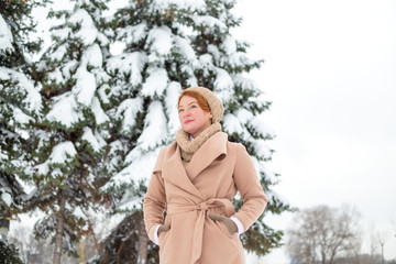 Portrait of a woman on a winter background.