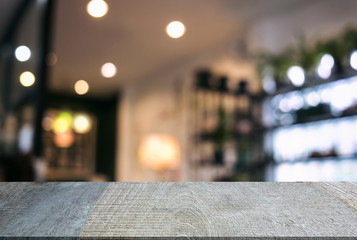 Empty wooden table and blurred background of abstract in front of restaurant or coffee shop for display of product or for montage
