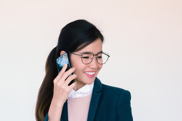 Young asian woman talking on her smartphone