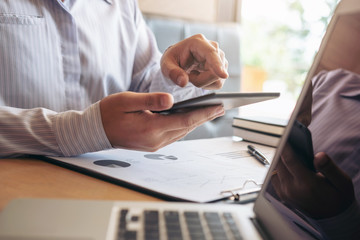 Executive businessman analysis working Financial investment on tablet Analyze business and market growth on financial document data graph