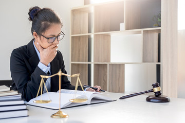 Judge gavel with scales of justice, professional female lawyers working having at law firm in...