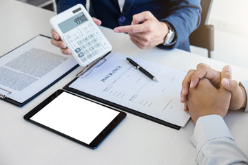 Businessman being analysis and making the decision a car insurance policy, Agent man is using calculator to presentation detail and waiting for his reply to finish