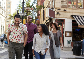 Group Of Friends Crossing Urban Street In New York City