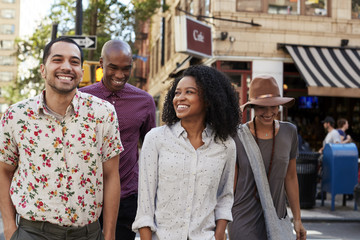 Group Of Friends Crossing Urban Street In New York City