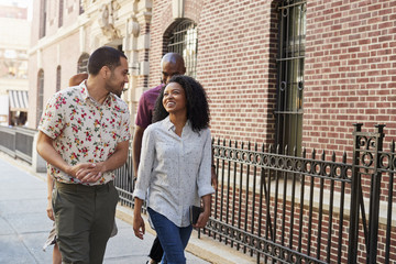 Group Of Friends Walking Along Urban Street In New York City