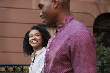 Obraz premium Young Couple Walking Along Urban Street In New York City
