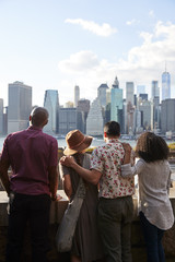 Rear View Of Tourists Looking At Manhattan Skyline