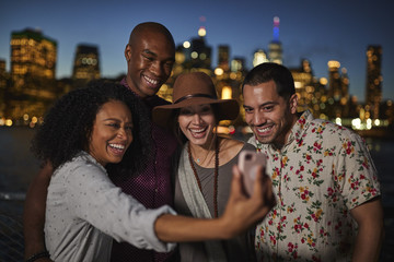 Group Of Friends Posing For Selfie In Front Of Manhattan Skyline
