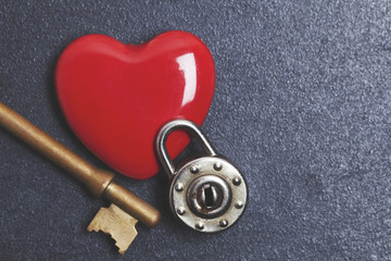 Valentines unlock love concept. Red heart with padlock and key