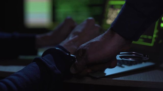 Cyber police catching and arresting hacker during committing cybercrime, justice