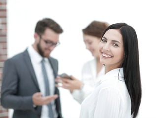 close-up of a beautiful woman manager and co-workers in the office
