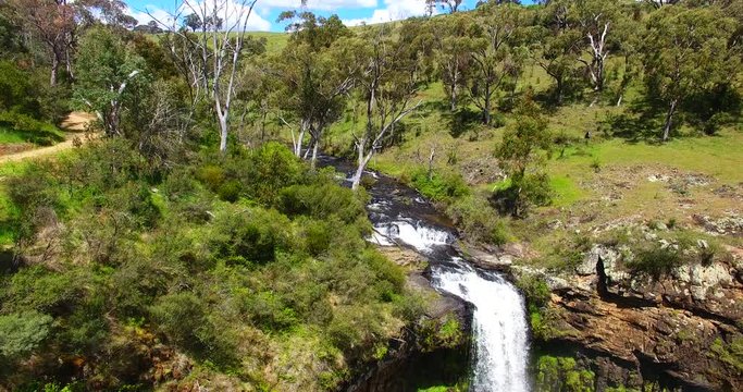 Pan right aerial, river waterfall in Australia