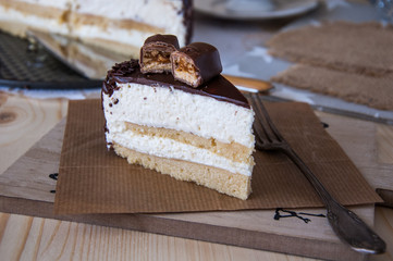 Cake piece Pigeon milk on a wooden background