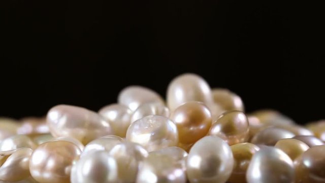 Real White And Gold Pearls Close Up Macro on Black Background.