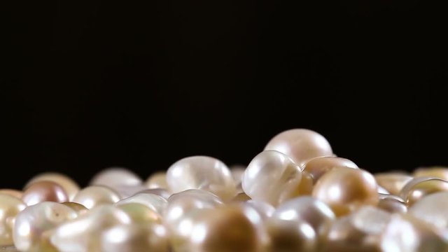 Real White And Gold Pearls Close Up Macro on Black Background.