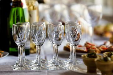 wine glasses on a buffet table with appetizers