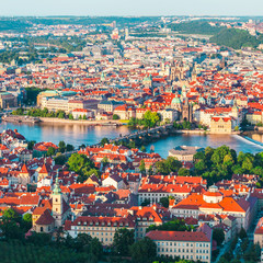 Fototapeta na wymiar Panorama of the old part of Prague from the Petrin tower. Beautiful view on the bridges over the river Vltava at sunset. Old Town architecture, Czech Republic.