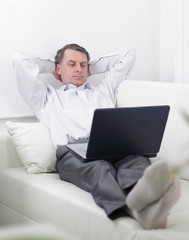 .businessman with laptop relaxing in the hotel room