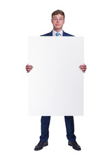 Businessman in blue siut holding blank banner board, isolated over white background.