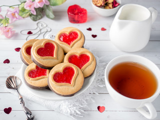 Fototapeta na wymiar Homemade Cookies with a Red Jam Heart Valentine's Day Cup of tea