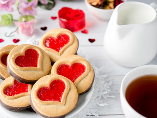Obraz na płótnie Canvas Homemade Cookies with a Red Jam Heart Valentine's Day Cup of tea