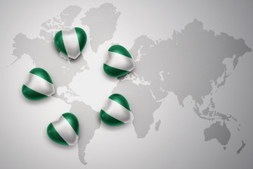 five hearts with national flag of nigeria on a world map background.