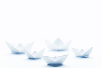paper boats on a white matte background