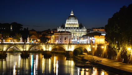 Fototapeta na wymiar Night view of Tiber with St. Peter's Basilica and Ponte Sant'Angelo, Rome, Italy