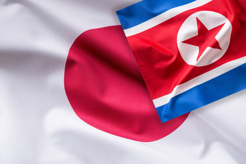 Fototapeta premium Japan and North Korea flag. Colorful Japan and North Korea flag waving in the wind
