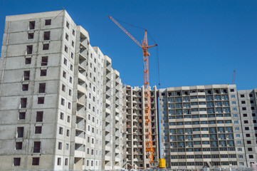 Obraz na płótnie Canvas Construction work site and hoisting tower cranes
