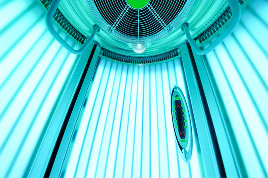 An empty solarium for sunbathing in a beauty salon or a spa with included ultraviolet lamps