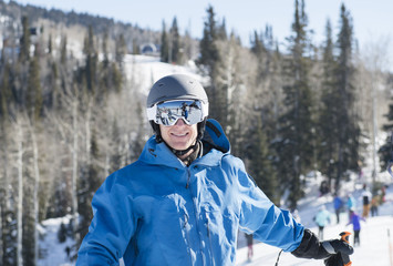 Fototapeta na wymiar Young Man on Mountain at a Resort in Colorado Ready to Ski with all Safety Equipment