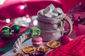 warm winter mug with marshmallow and macaroons